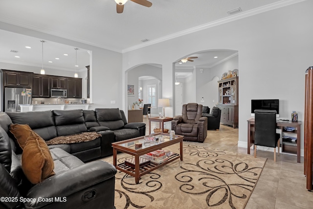 2922 Addison Dr, Melbourne, FL 32940 - living room featuring ceiling fan, arched walkways, crown molding, light tile patterned floors, and recessed lighting