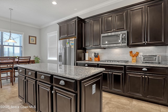 2922 Addison Dr, Melbourne, FL 32940 - kitchen featuring appliances with stainless steel finishes, crown molding, backsplash, decorative light fixtures, and light stone counters