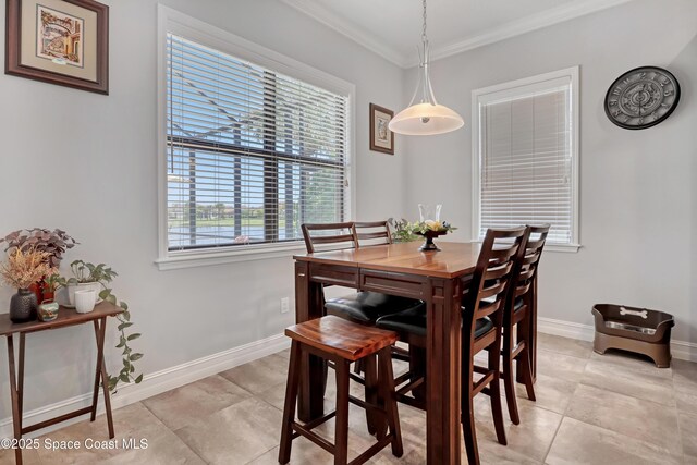 2922 Addison Dr, Melbourne, FL 32940 - dining space featuring crown molding, light tile patterned flooring, and baseboards