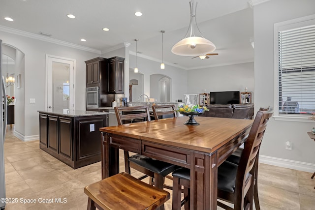 2922 Addison Dr, Melbourne, FL 32940 - dining space with arched walkways, baseboards, recessed lighting, ornamental molding, and light tile patterned floors