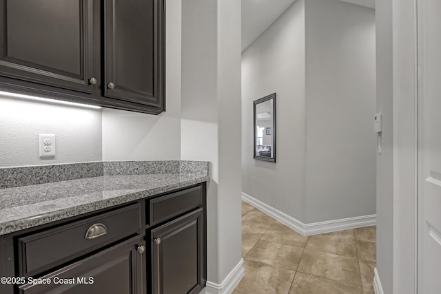 2922 Addison Dr, Melbourne, FL 32940 - bar area with baseboards and light tile patterned floors