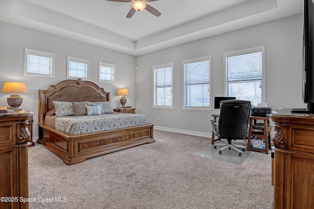 2922 Addison Dr, Melbourne, FL 32940 - bedroom featuring a tray ceiling, light carpet, a desk, a ceiling fan, and baseboards