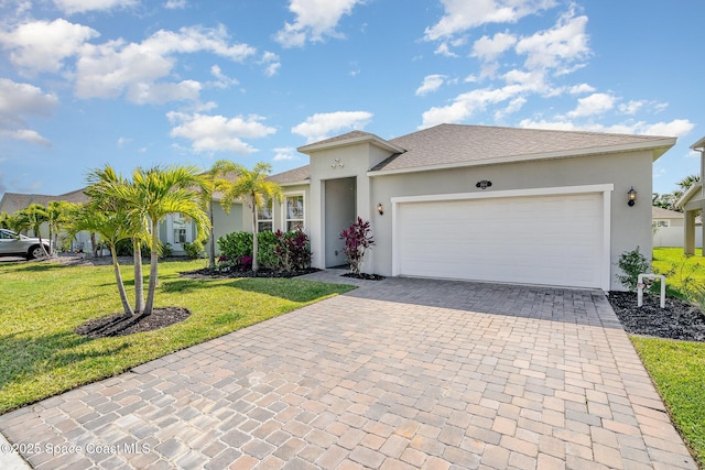 single story home featuring stucco siding, decorative driveway, an attached garage, and a front yard