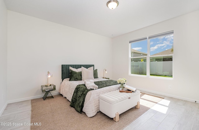 bedroom featuring baseboards and light wood-type flooring