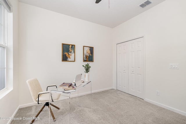 carpeted office featuring ceiling fan and baseboards