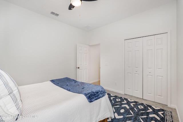 bedroom with light carpet, a closet, baseboards, and ceiling fan