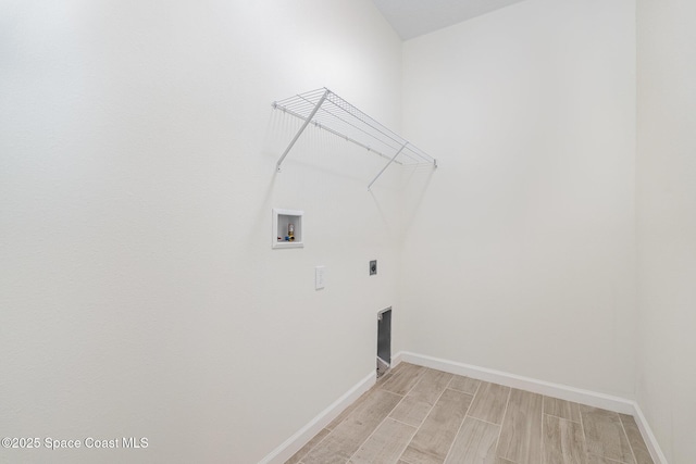 laundry area with hookup for a washing machine, baseboards, hookup for an electric dryer, and wood tiled floors