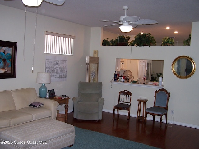 4077 Green Oak Dr, Melbourne, FL 32901 - living room featuring a ceiling fan, wood finished floors, and baseboards