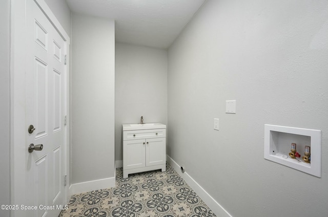 407 Sandpiper Dr, Satellite Beach, FL 32937 - washroom with baseboards, cabinet space, and hookup for a washing machine