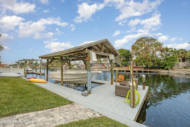407 Sandpiper Dr, Satellite Beach, FL 32937 - dock area with boat lift, a water view, and a yard