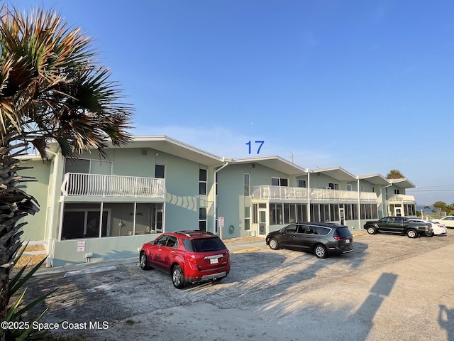 2625 S Atlantic Ave Unit 17, Cocoa Beach, FL 32931 - view of building exterior featuring uncovered parking