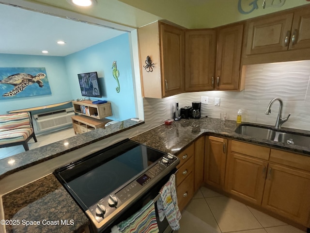 2625 S Atlantic Ave Unit 17, Cocoa Beach, FL 32931 - kitchen featuring a sink, electric stove, dark stone counters, brown cabinetry, and decorative backsplash