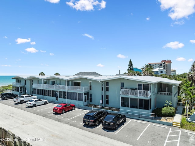 2625 S Atlantic Ave Unit 17, Cocoa Beach, FL 32931 - view of building exterior featuring uncovered parking and a water view
