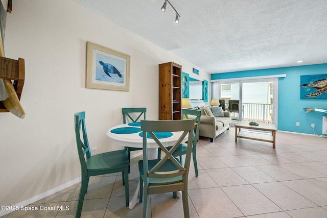 2625 S Atlantic Ave Unit 17, Cocoa Beach, FL 32931 - dining area featuring a textured ceiling, baseboards, and light tile patterned floors