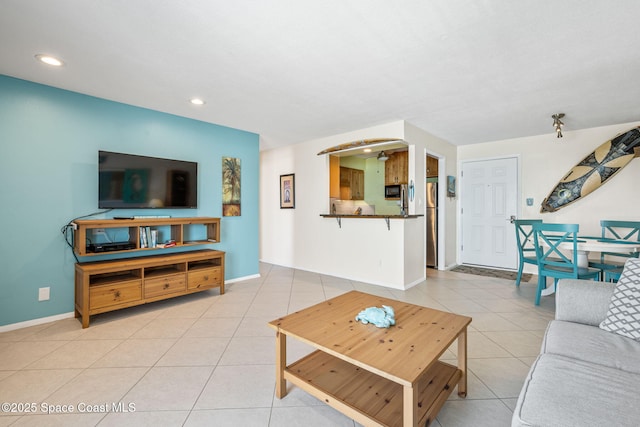 2625 S Atlantic Ave Unit 17, Cocoa Beach, FL 32931 - living room featuring light tile patterned floors, baseboards, and recessed lighting