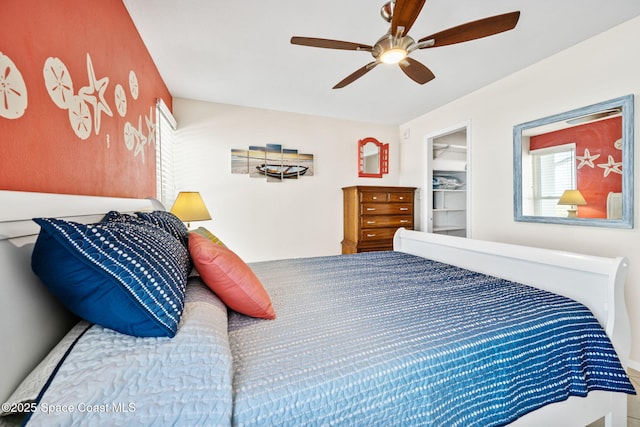 2625 S Atlantic Ave Unit 17, Cocoa Beach, FL 32931 - bedroom featuring a ceiling fan and a walk in closet