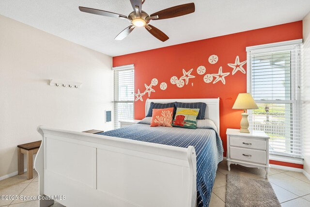 2625 S Atlantic Ave Unit 17, Cocoa Beach, FL 32931 - tiled bedroom featuring a ceiling fan and baseboards