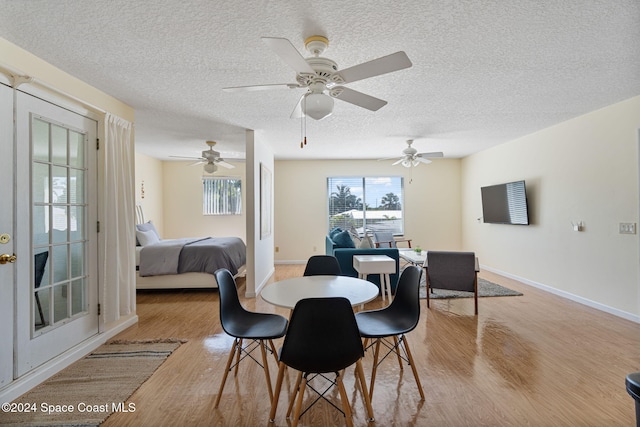 921 S Orlando Ave, Cocoa Beach, FL 32931 - dining room featuring wood finished floors, a textured ceiling, baseboards, and ceiling fan