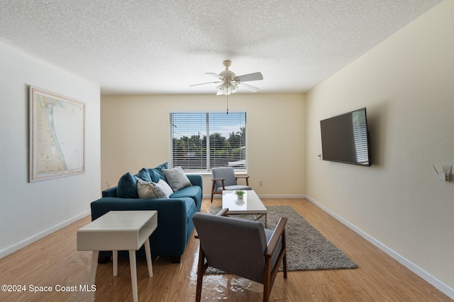 921 S Orlando Ave, Cocoa Beach, FL 32931 - living area featuring light wood finished floors, ceiling fan, a textured ceiling, and baseboards