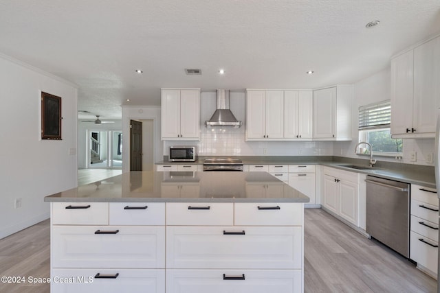 921 S Orlando Ave, Cocoa Beach, FL 32931 - kitchen featuring a sink, appliances with stainless steel finishes, wall chimney exhaust hood, a kitchen island, and tasteful backsplash