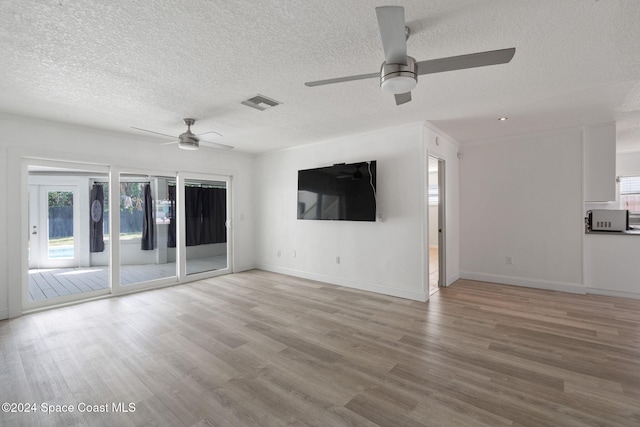 921 S Orlando Ave, Cocoa Beach, FL 32931 - unfurnished living room with ceiling fan, a textured ceiling, wood finished floors, and baseboards