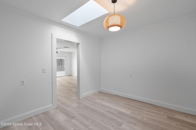 921 S Orlando Ave, Cocoa Beach, FL 32931 - unfurnished room with a skylight, light wood finished floors, ornamental molding, and baseboards