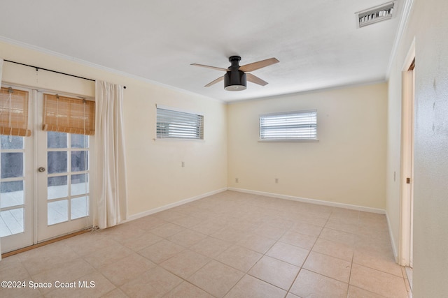 921 S Orlando Ave, Cocoa Beach, FL 32931 - spare room with french doors, a ceiling fan, crown molding, baseboards, and light tile patterned flooring