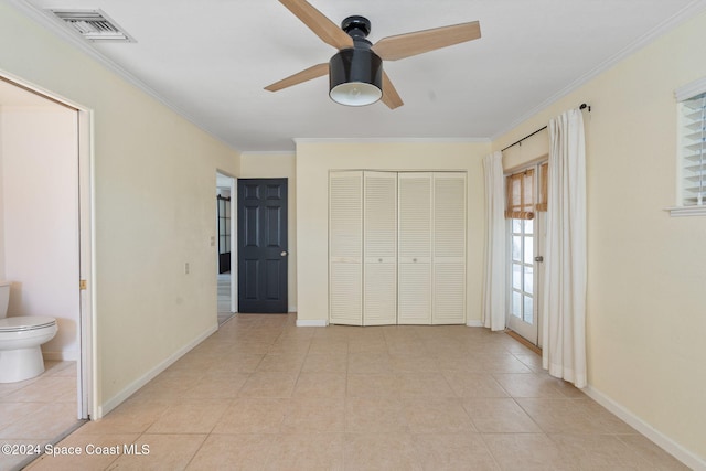921 S Orlando Ave, Cocoa Beach, FL 32931 - unfurnished bedroom with ornamental molding, light tile patterned flooring, baseboards, a closet, and ceiling fan