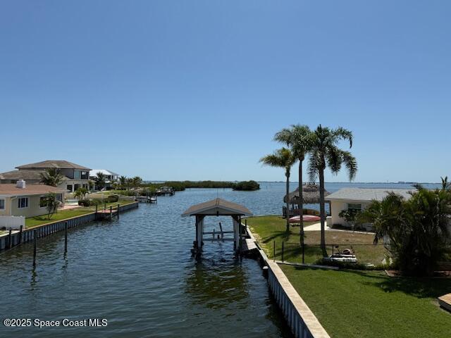 1700 Neptune Dr, Merritt Island, FL 32952 - dock area with a water view and a yard