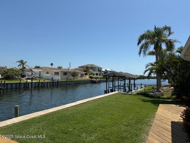 1700 Neptune Dr, Merritt Island, FL 32952 - dock area featuring a water view, a yard, and a residential view