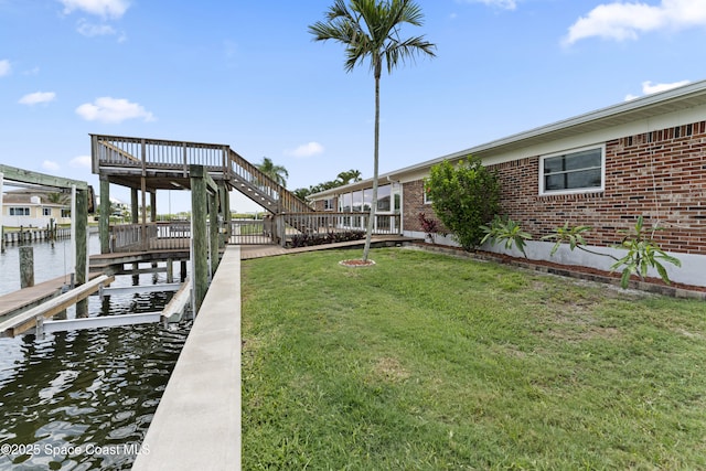 1700 Neptune Dr, Merritt Island, FL 32952 - dock featuring a lawn, a water view, and boat lift