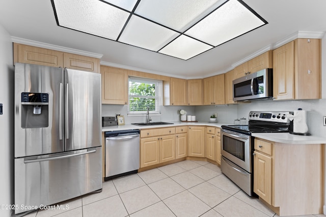 1700 Neptune Dr, Merritt Island, FL 32952 - kitchen featuring appliances with stainless steel finishes, light brown cabinets, a sink, light countertops, and light tile patterned floors