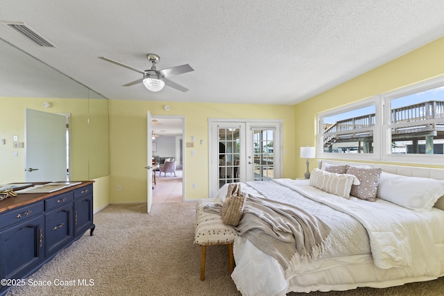 1700 Neptune Dr, Merritt Island, FL 32952 - bedroom with access to outside, light carpet, a textured ceiling, ceiling fan, and baseboards