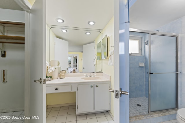 1700 Neptune Dr, Merritt Island, FL 32952 - full bath with vanity, a stall shower, plenty of natural light, tile patterned flooring, and recessed lighting