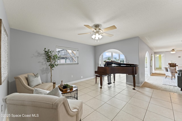 1700 Neptune Dr, Merritt Island, FL 32952 - living room featuring a ceiling fan, plenty of natural light, baseboards, and a textured ceiling