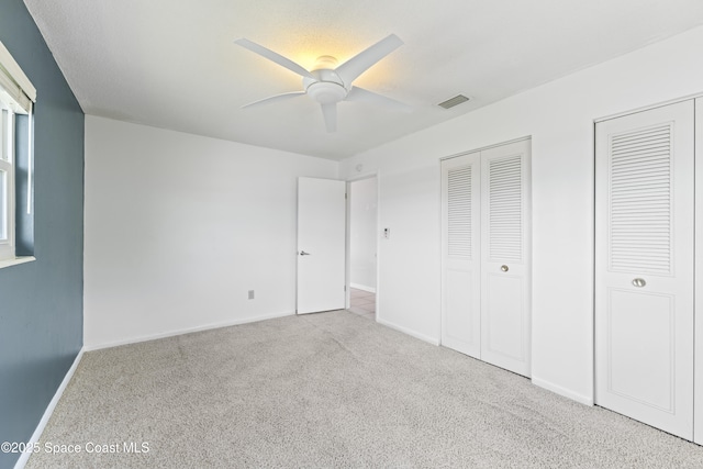 1700 Neptune Dr, Merritt Island, FL 32952 - unfurnished bedroom with carpet floors, baseboards, and a ceiling fan