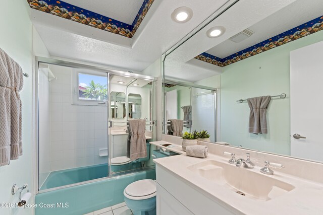 1700 Neptune Dr, Merritt Island, FL 32952 - full bathroom with vanity, toilet, combined bath / shower with glass door, a textured ceiling, and tile patterned flooring