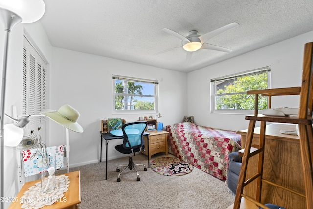 1700 Neptune Dr, Merritt Island, FL 32952 - bedroom with carpet floors, a textured ceiling, a closet, a ceiling fan, and baseboards
