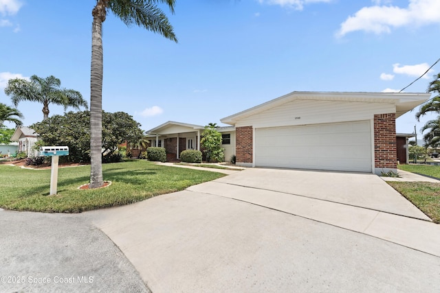 1700 Neptune Dr, Merritt Island, FL 32952 - ranch-style home with brick siding, a front lawn, concrete driveway, and an attached garage