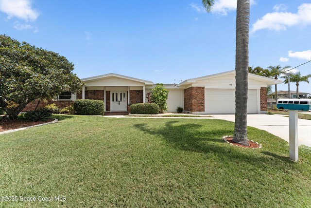 1700 Neptune Dr, Merritt Island, FL 32952 - view of front of house with brick siding, an attached garage, concrete driveway, and a front yard