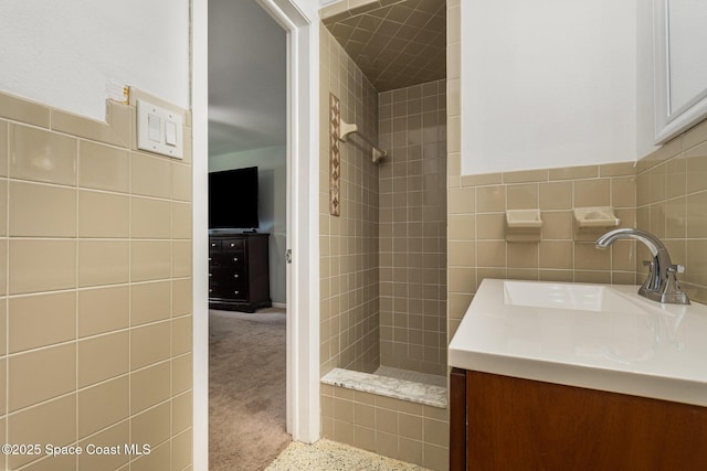 365 Belair Ave, Merritt Island, FL 32953 - full bathroom featuring tile walls, tiled shower, vanity, and a wainscoted wall