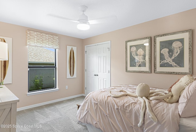1421 San Filippo Dr SE, Palm Bay, FL 32909 - bedroom with light carpet, baseboards, a ceiling fan, and a closet