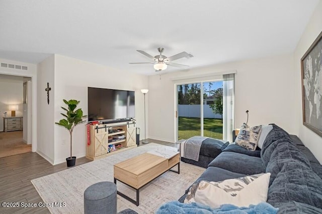 966 Stage St SE, Palm Bay, FL 32909 - living area with a ceiling fan, wood finished floors, and baseboards