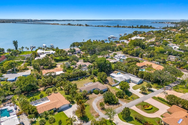 aerial view of residential area with a notable bridge and a large body of water