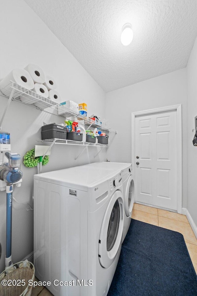 471 Hallmark St SE, Palm Bay, FL 32909 - laundry room with independent washer and dryer, a textured ceiling, light tile patterned flooring, and baseboards
