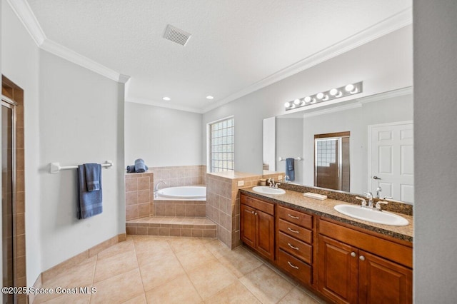 471 Hallmark St SE, Palm Bay, FL 32909 - bathroom with tile patterned floors, a bath, ornamental molding, a tile shower, and double vanity
