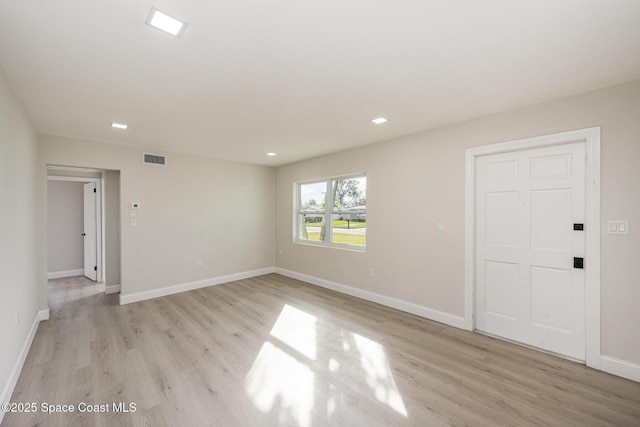 118 1st St, Merritt Island, FL 32953 - empty room with light wood-style flooring, baseboards, and recessed lighting