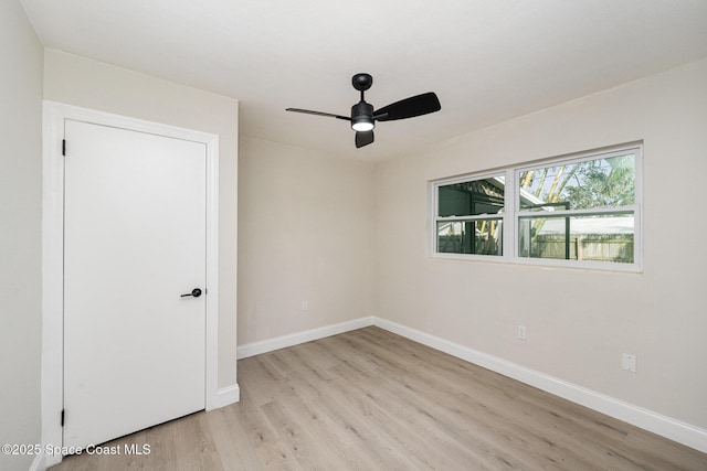 118 1st St, Merritt Island, FL 32953 - spare room featuring light wood-style floors, baseboards, and a ceiling fan