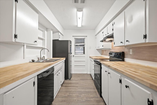 kitchen featuring black appliances, under cabinet range hood, a sink, and white cabinets