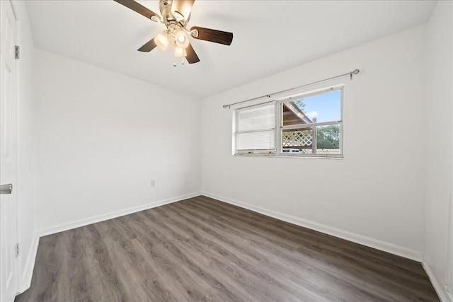 spare room with wood finished floors, baseboards, and ceiling fan